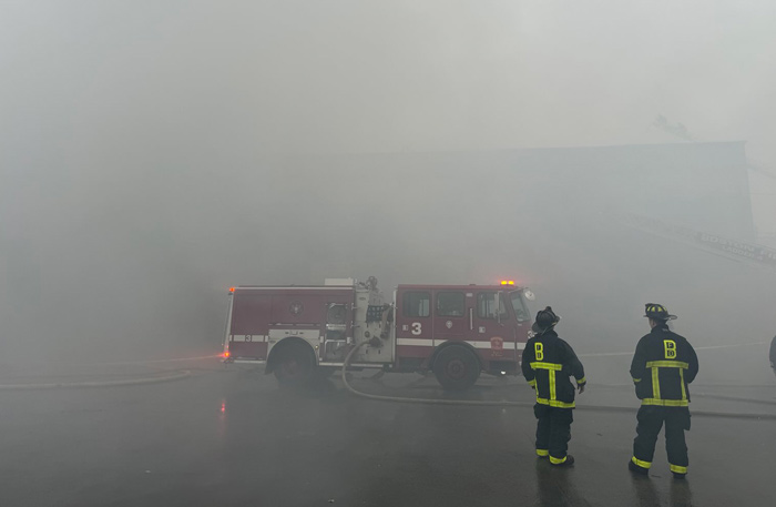 Firefighters in thick smoke at fire