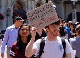 Wayfair worker holding sign reading Endless Detention is Torture