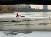 Man picking up cones on the Charles River