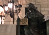 Statue of Art holding a sign reading: Defend Roe