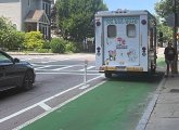 Ice-cream truck parked in a bike lane