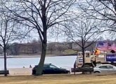 A couple of vehicles adorned with American and Trump flags