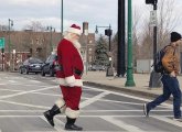 Santa crossing Washington Street to the Forest Hills T station