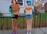 Two kids with pro trans rights signs