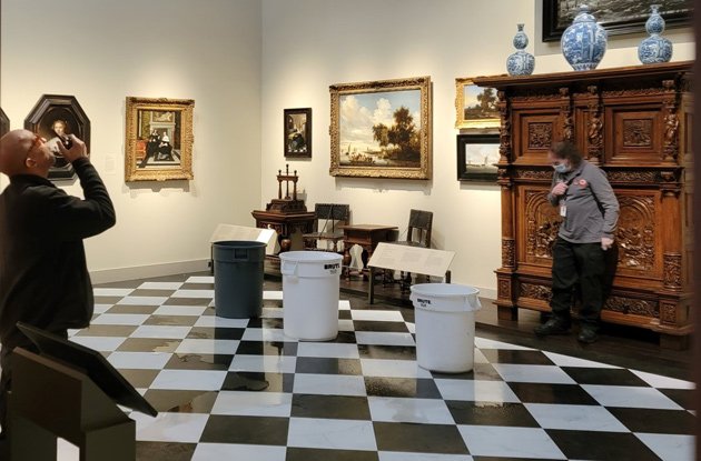 Color-coordinated trash barrels catch water at MFA exhibit