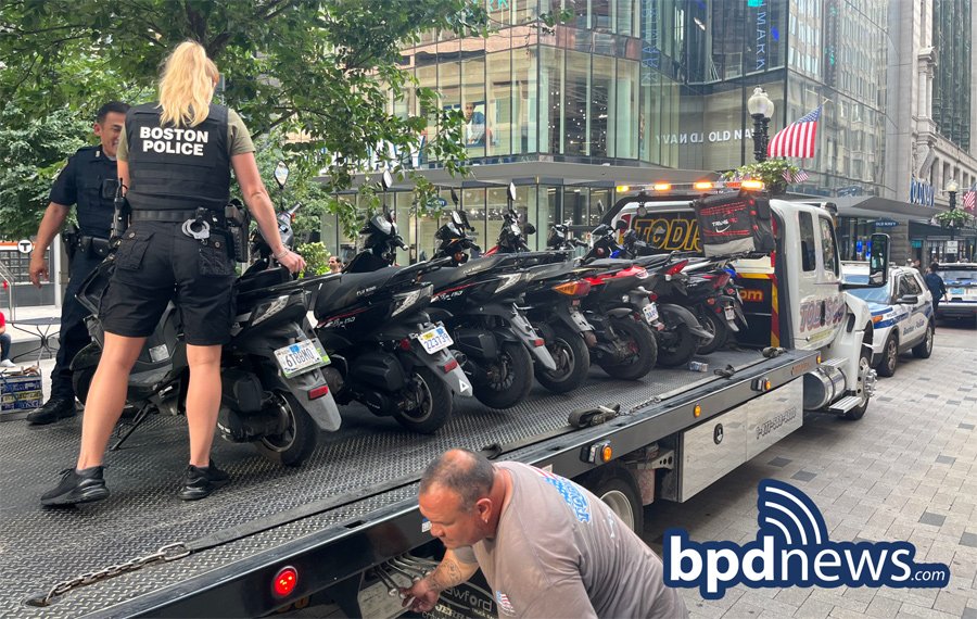 Police, tow worker getting scooters ready for transport somewhere else