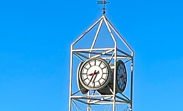 One side of the clock at Forest Hills is about 10 minutes fast