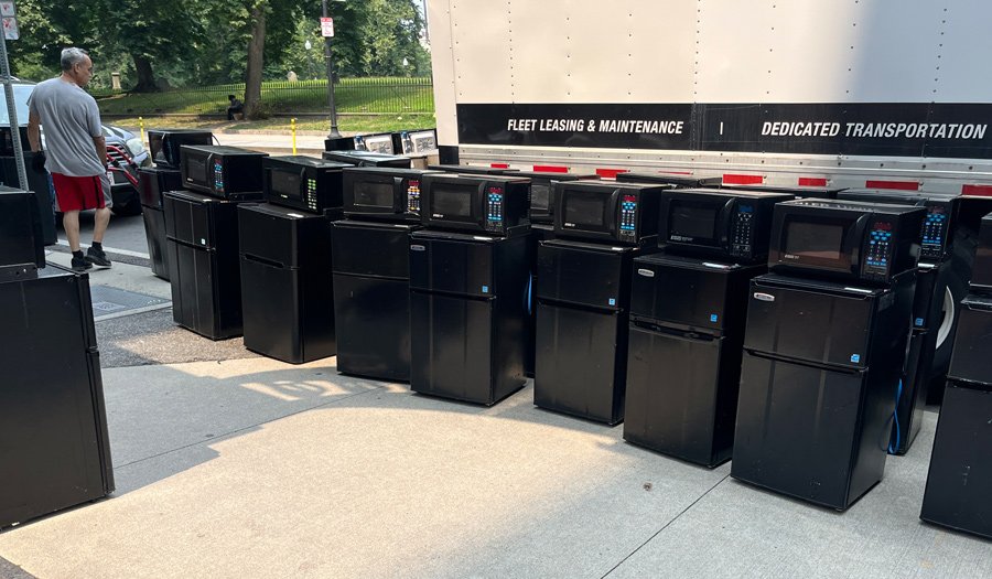 Dorm fridges and microwaves getting unloaded at Emerson