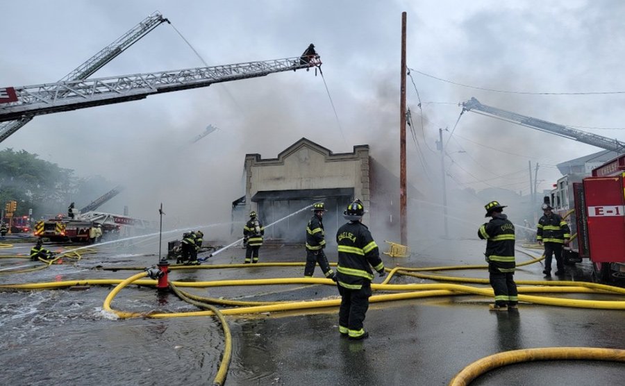 Firefighters pour water on Russo's fire