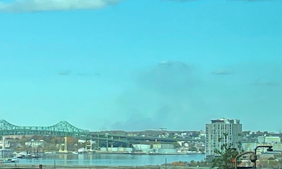 Clearer skies, but with smoke still rising north of Boston