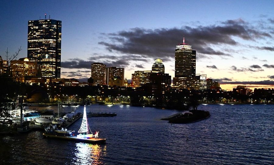 Sunset over the Charles River Lagoon and the Community Boating Christmas boat